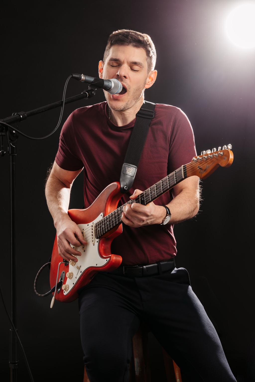George Kramer at the microphone with his red Stratocaster